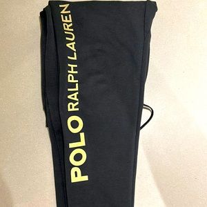 Black with gold lettering size medium men’s track pants.